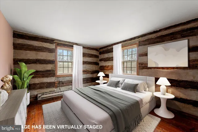 a view of an empty room with wooden floor and closet