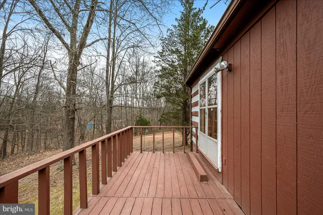 a view of balcony with wooden floor and fence