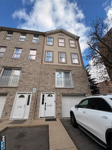 a view of a brick house with many windows