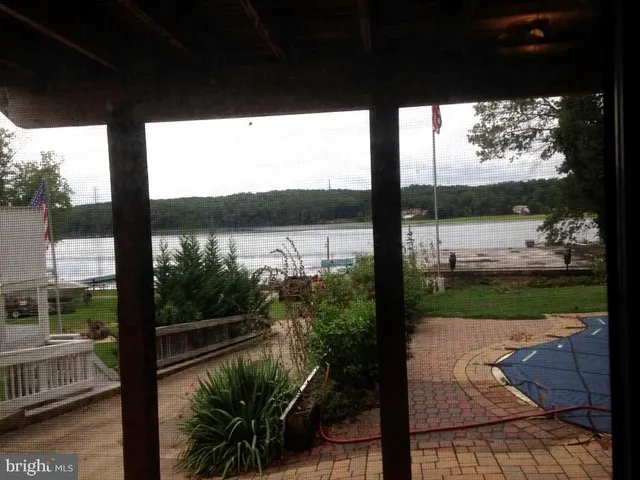 a view of a porch with furniture and garden