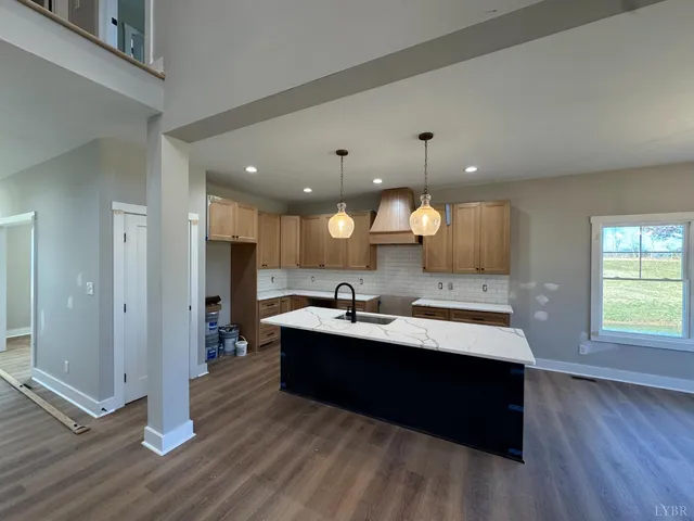a view of a kitchen counter space with wooden floor and sink