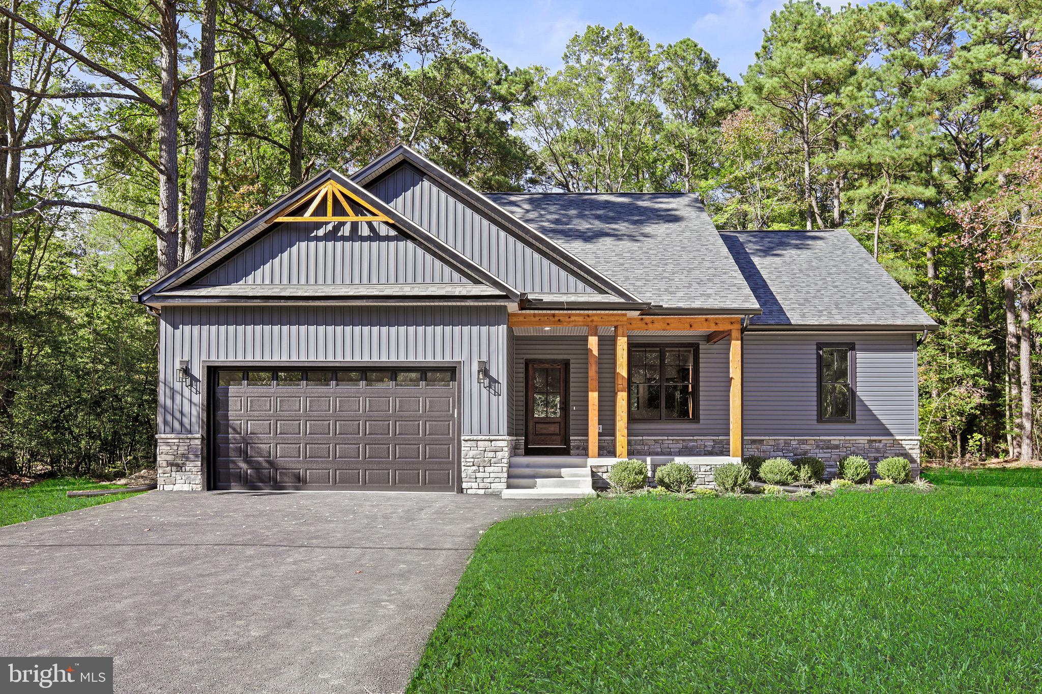 a front view of a house with a garden and plants