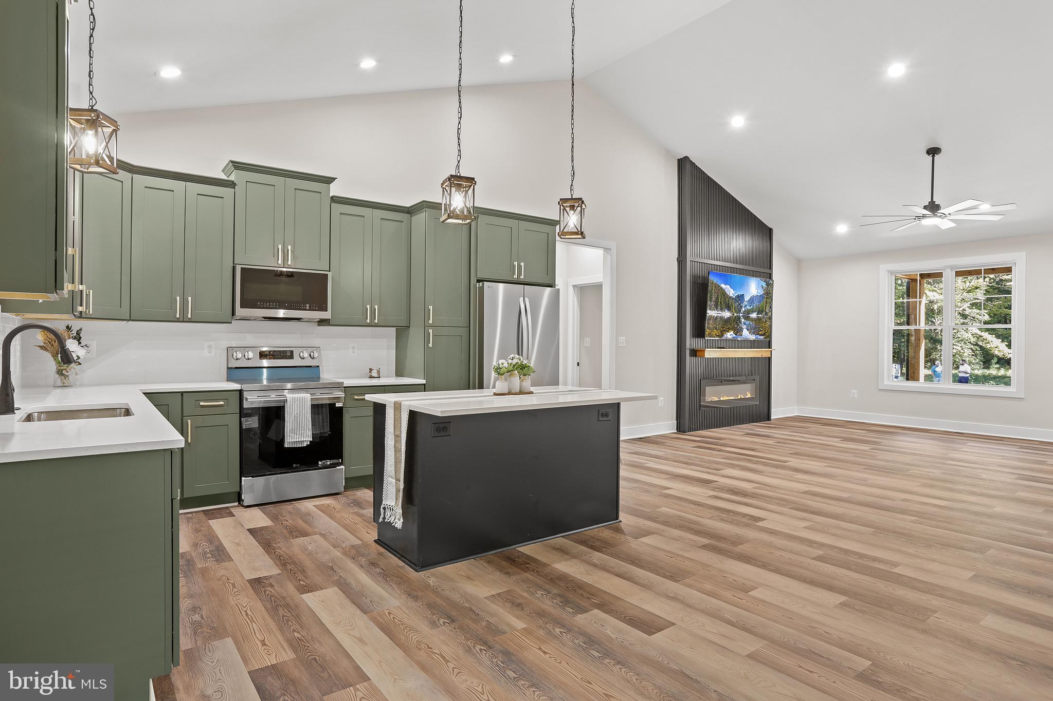 195 North Glebe Road Montross, VA 22520 - Photo 12 of 53 a large kitchen with kitchen island a sink stainless steel appliances and cabinets