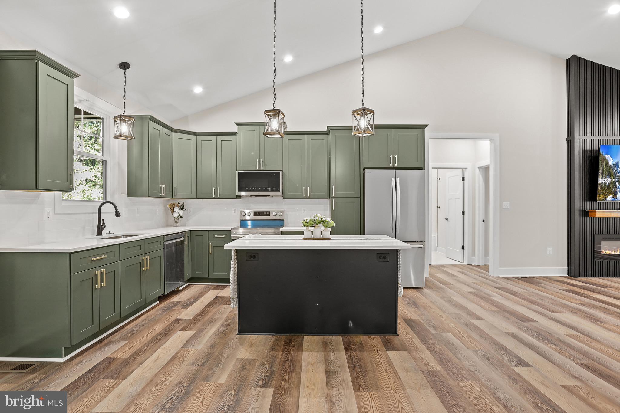 195 North Glebe Road Montross, VA 22520 - Photo 13 of 53 a large kitchen with kitchen island a sink stainless steel appliances and cabinets