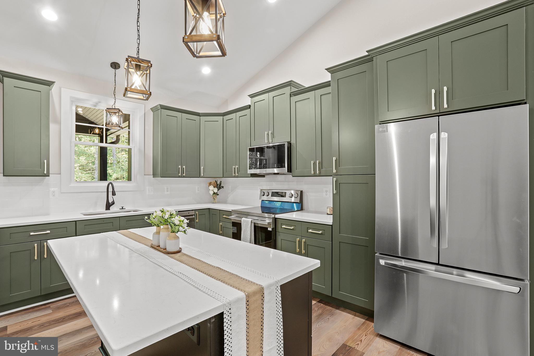 195 North Glebe Road Montross, VA 22520 - Photo 17 of 53 a kitchen with kitchen island a sink appliances and cabinets