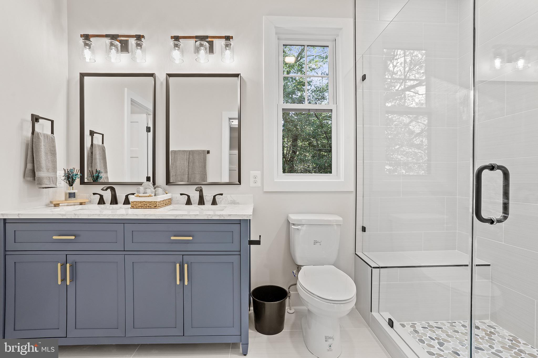 195 North Glebe Road Montross, VA 22520 - Photo 25 of 53 a bathroom with a toilet a sink and glass door