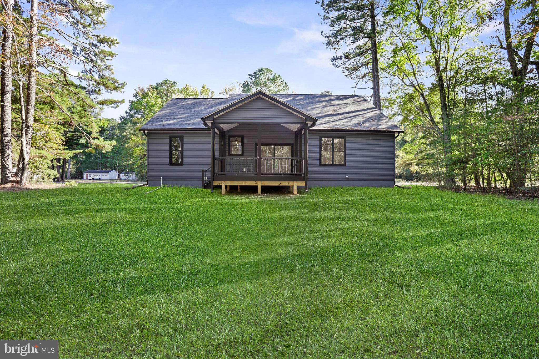 195 North Glebe Road Montross, VA 22520 - Photo 37 of 53 a view of a brick house with a big yard and large trees