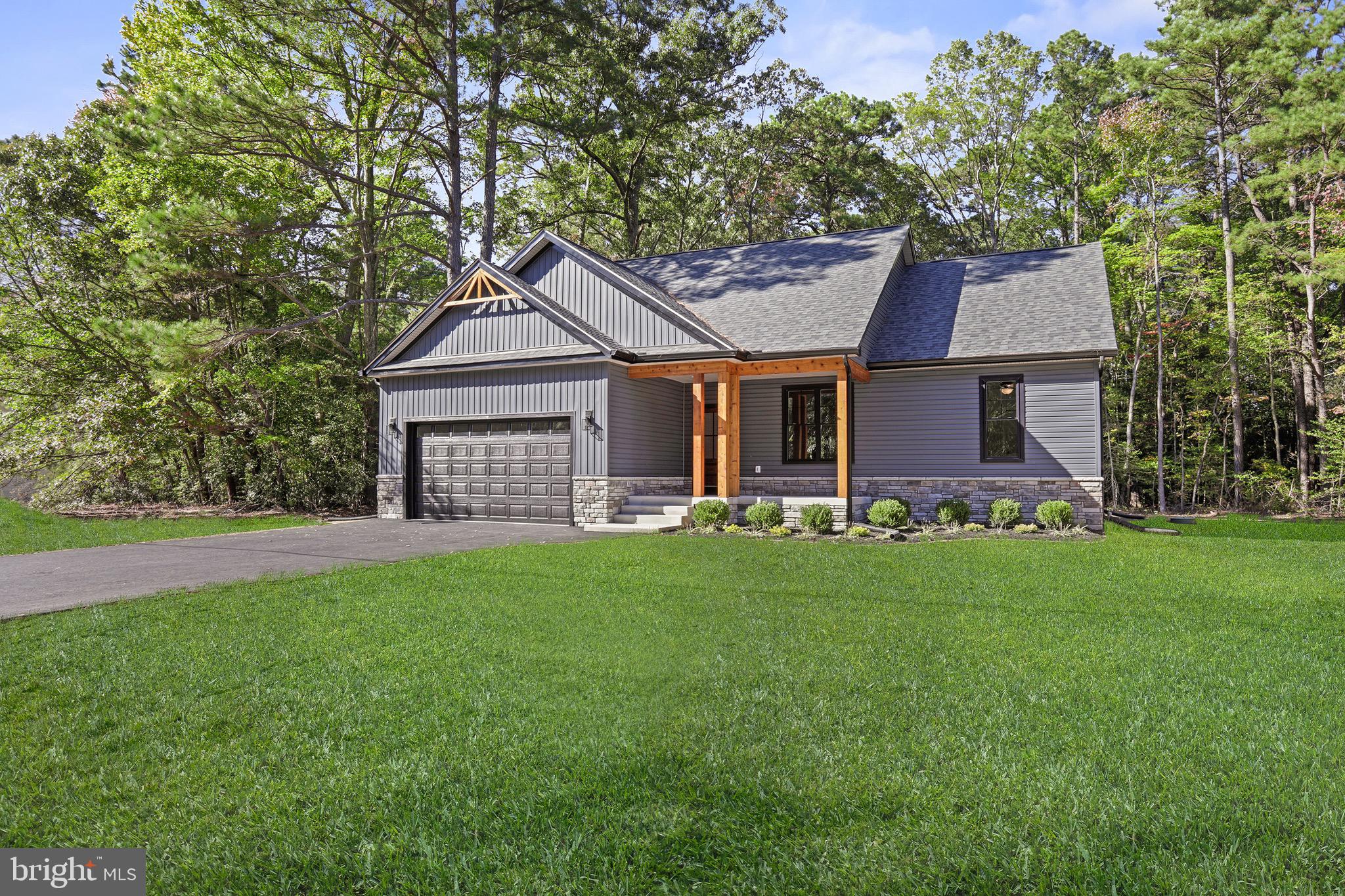 195 North Glebe Road Montross, VA 22520 - Photo 38 of 53 a front view of a house with a garden and yard