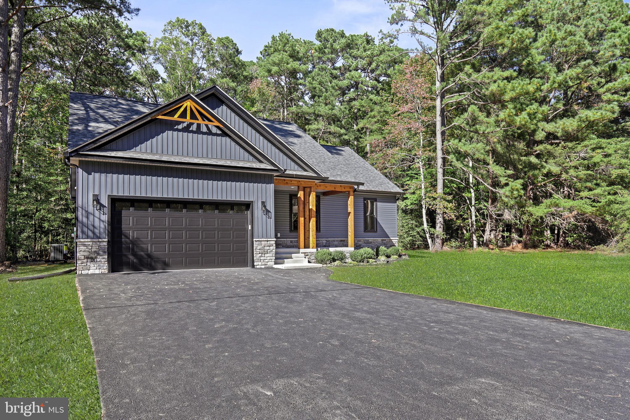 195 North Glebe Road Montross, VA 22520 - Photo 39 of 53 a front view of a house with a garden and yard