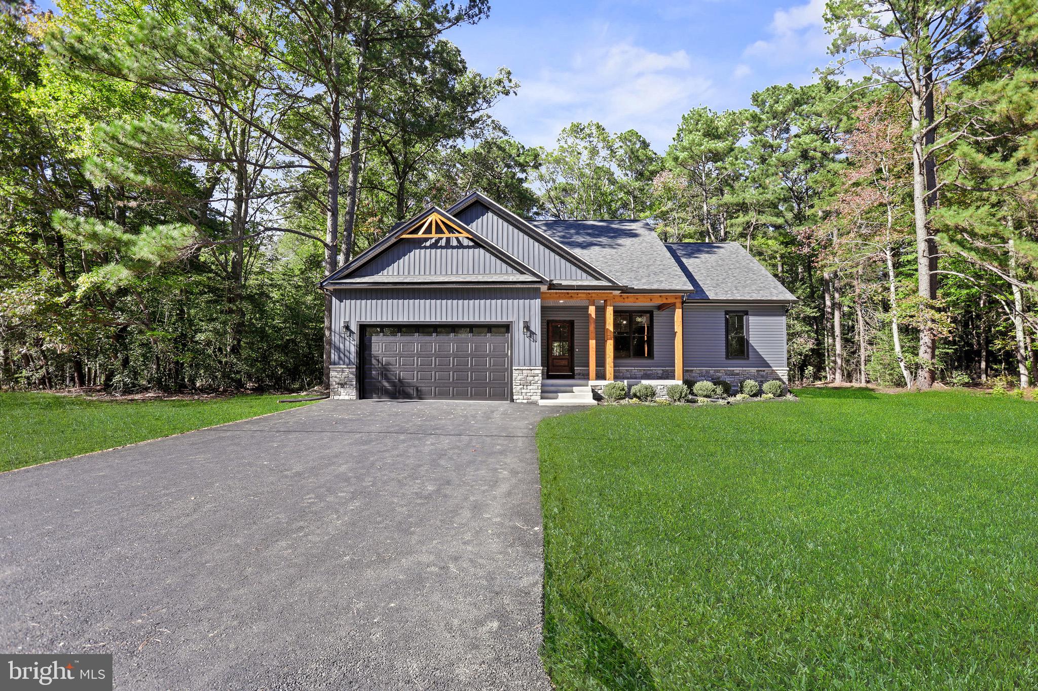195 North Glebe Road Montross, VA 22520 - Photo 4 of 53 a front view of a house with a garden and trees
