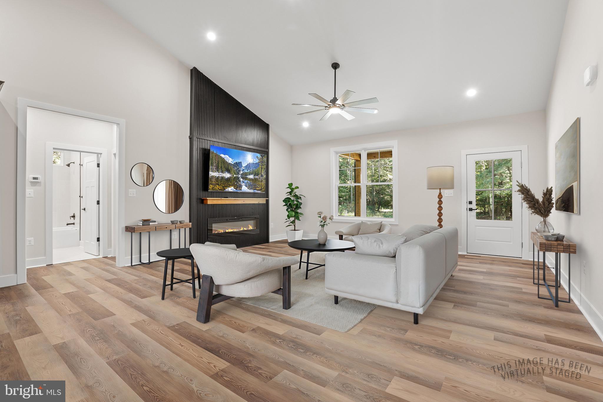 195 North Glebe Road Montross, VA 22520 - Photo 9 of 53 a living room with furniture a large window and a wooden floor