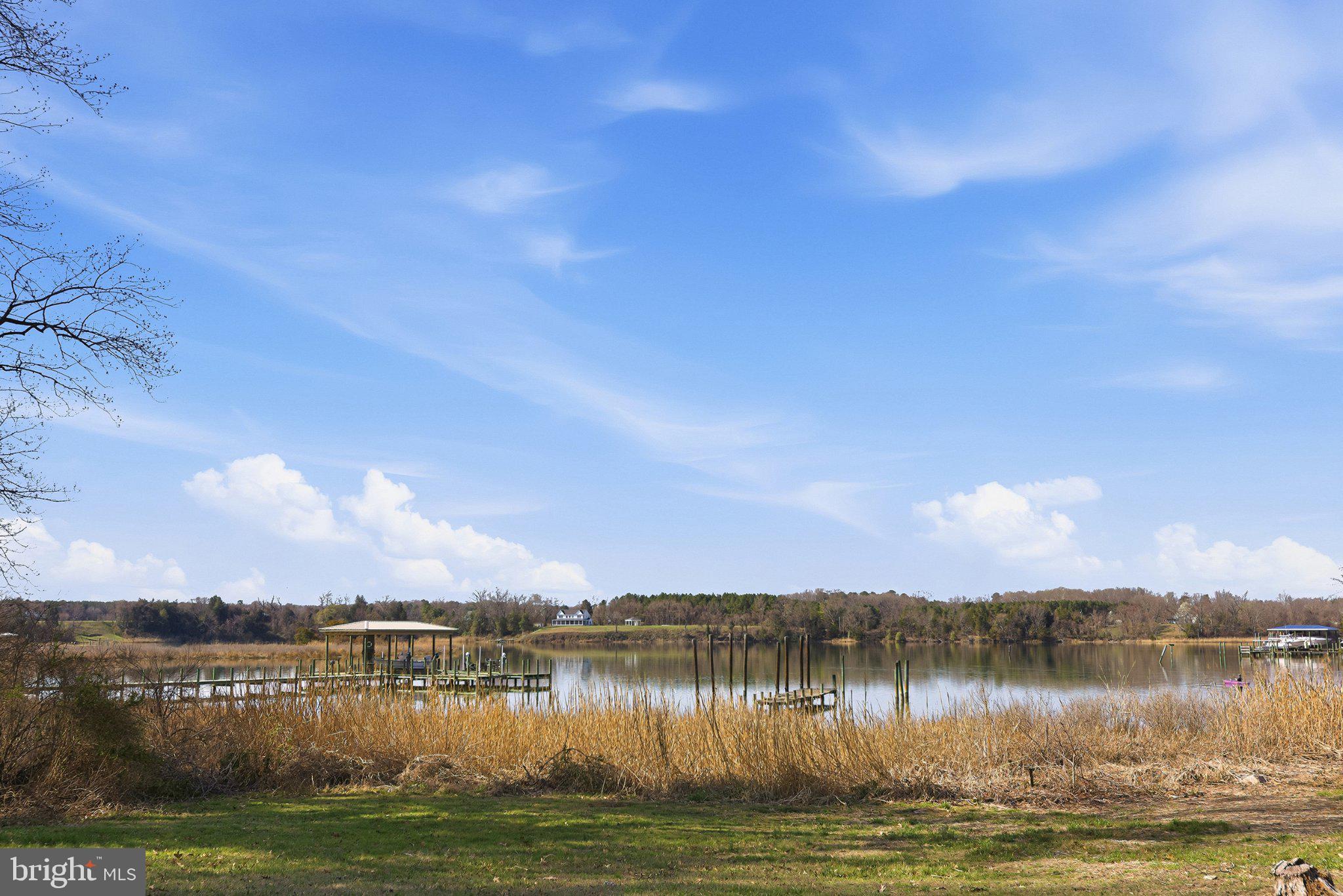 20289 Ridge Road Colonial Beach, VA 22443 - Photo 26 of 28 Serene lakeside view under blue skies.