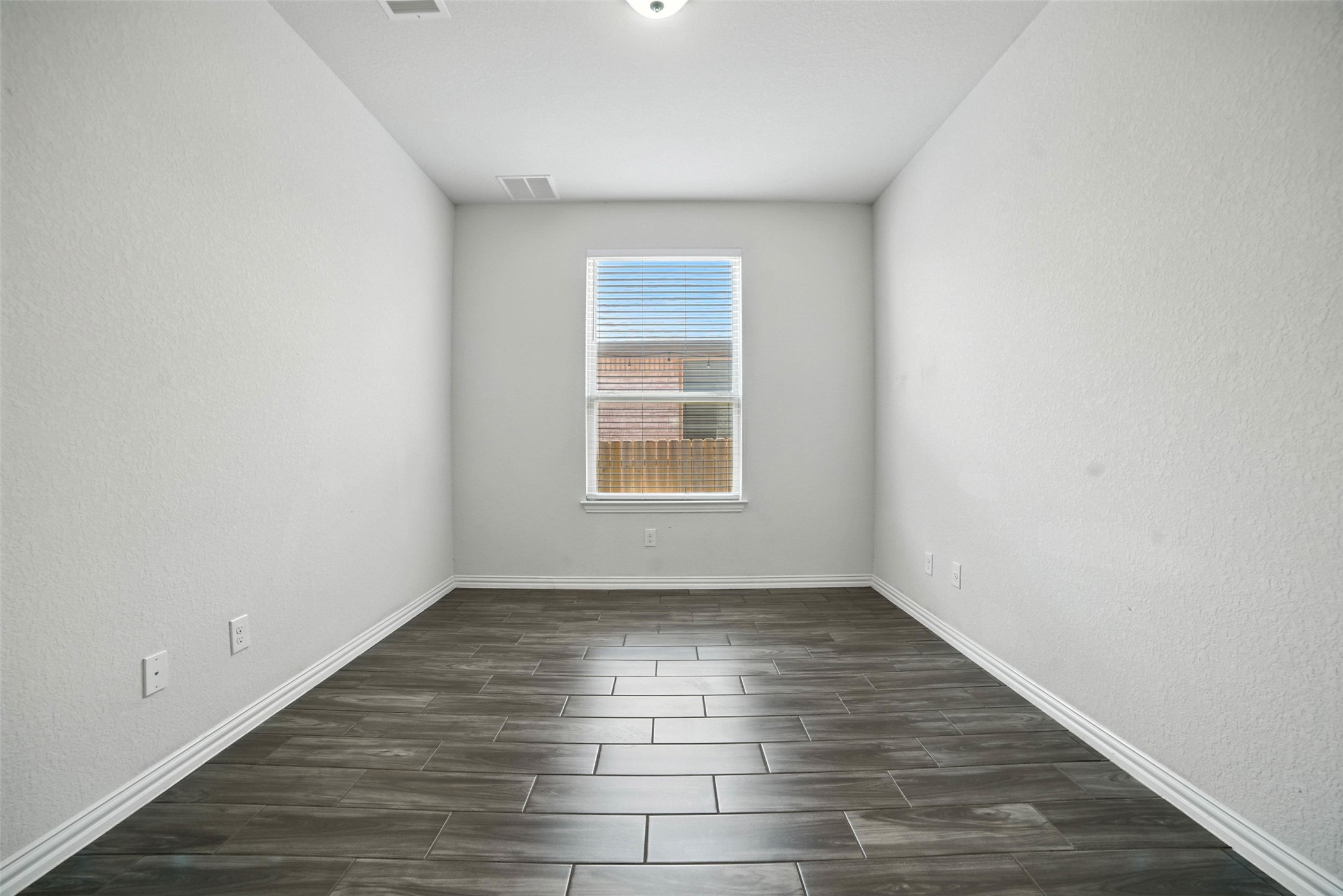 3054 Columbus Loop Round Rock, TX 78665 - Photo 13 of 40 Empty room featuring a textured wall and wood finish floors