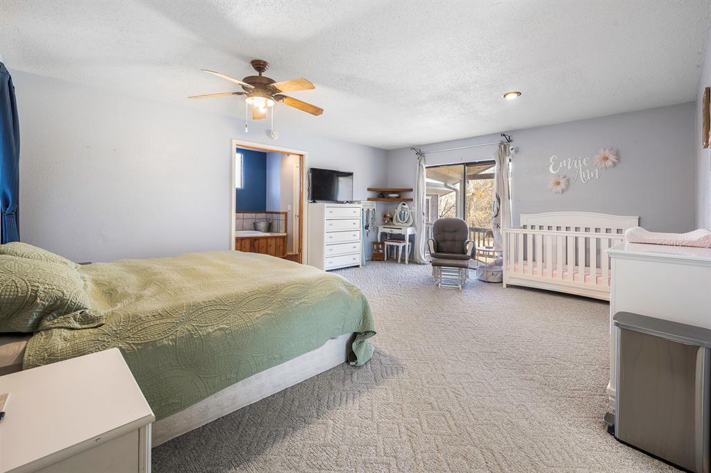 401 Sandy Lane Dublin, TX 76446 - Photo 12 of 39 a bedroom with a bed and a chandelier