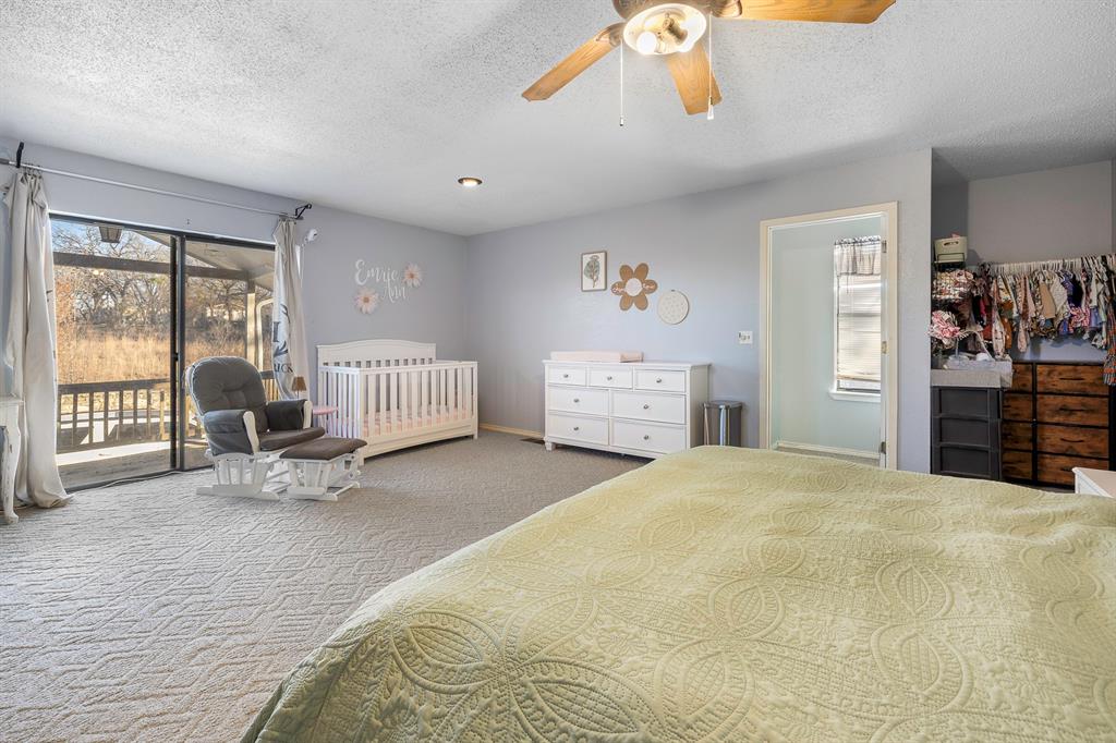 401 Sandy Lane Dublin, TX 76446 - Photo 13 of 39 a bedroom with a bed and a large window