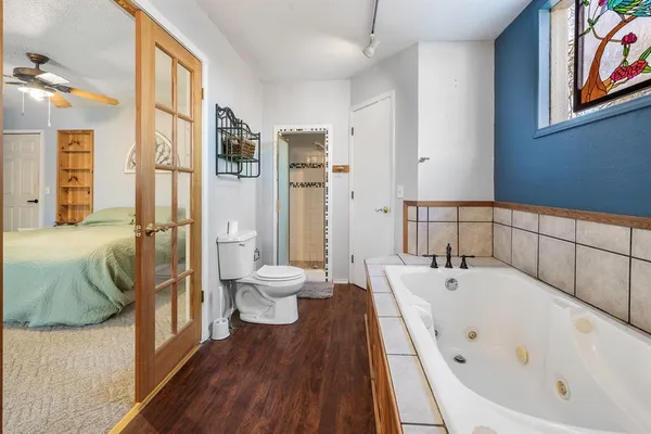 a bathroom with a bathtub and a toilet