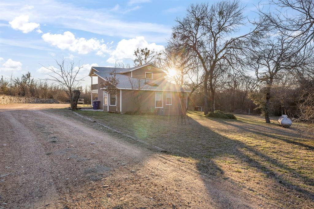 401 Sandy Lane Dublin, TX 76446 - Photo 2 of 39 a view of a yard with a large tree