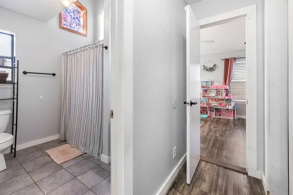 a bedroom with bed and a chandelier
