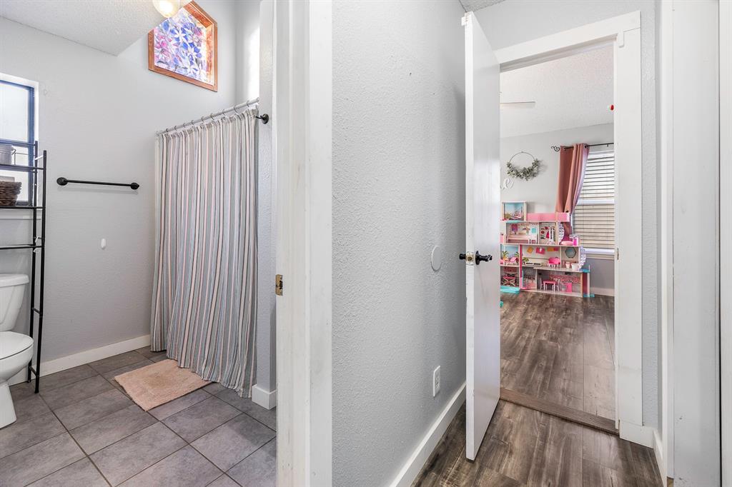 401 Sandy Lane Dublin, TX 76446 - Photo 21 of 39 a view of a hallway with wooden floor and dining room view