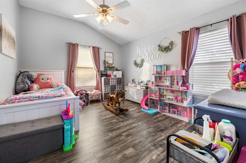 401 Sandy Lane Dublin, TX 76446 - Photo 22 of 39 a bedroom with bed and a chandelier