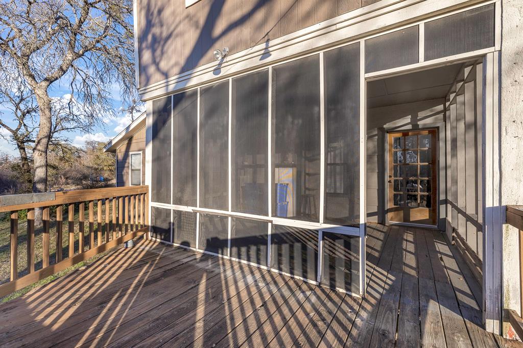 401 Sandy Lane Dublin, TX 76446 - Photo 24 of 39 a view of balcony with wooden floor and fence and a large window