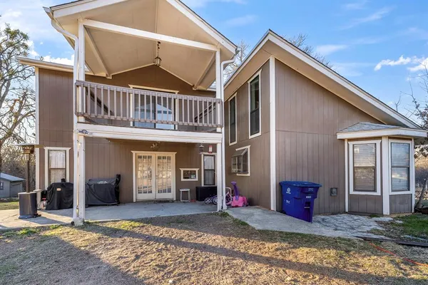 a front view of a house with barbeque and outdoor seating