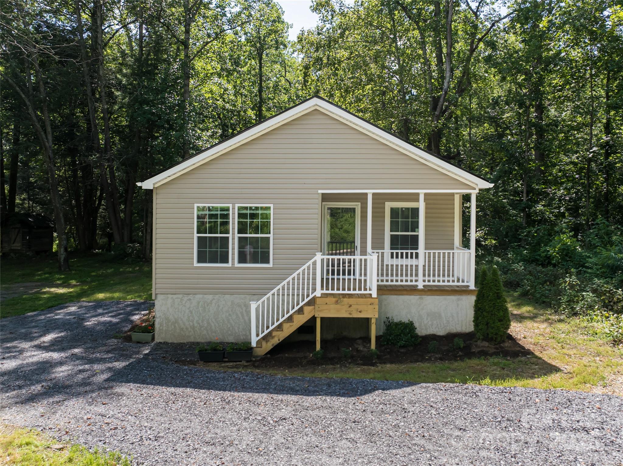 321 Flat Creek Road Black Mountain, NC 28711 - Photo 1 of 44 a front view of a house with garden