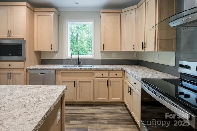 a kitchen with a sink stove top oven and cabinets
