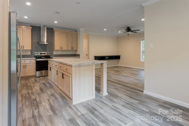 a kitchen with stainless steel appliances granite countertop a stove top oven a sink and a refrigerator