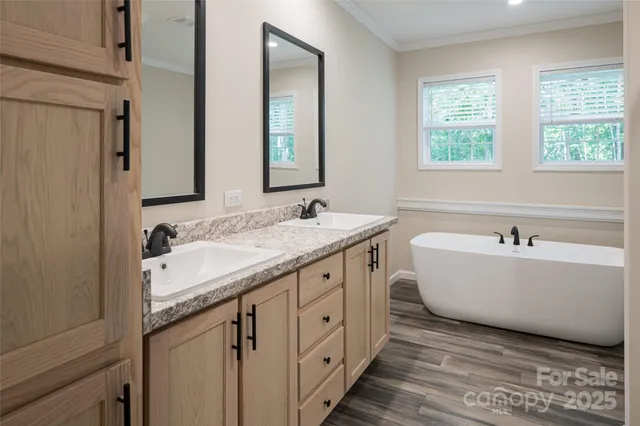 a bathroom with a granite countertop sink and a bathtub