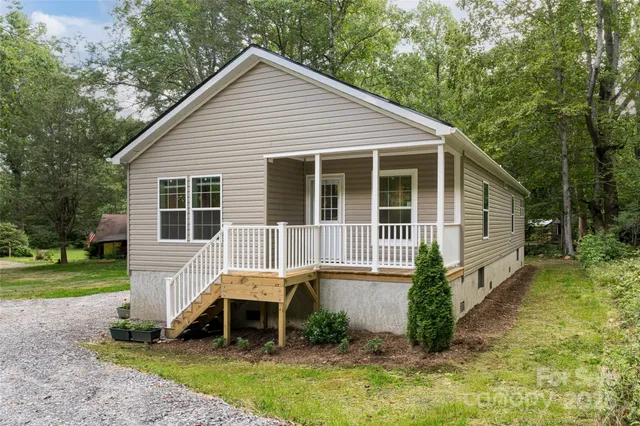a front view of a house with a yard and porch