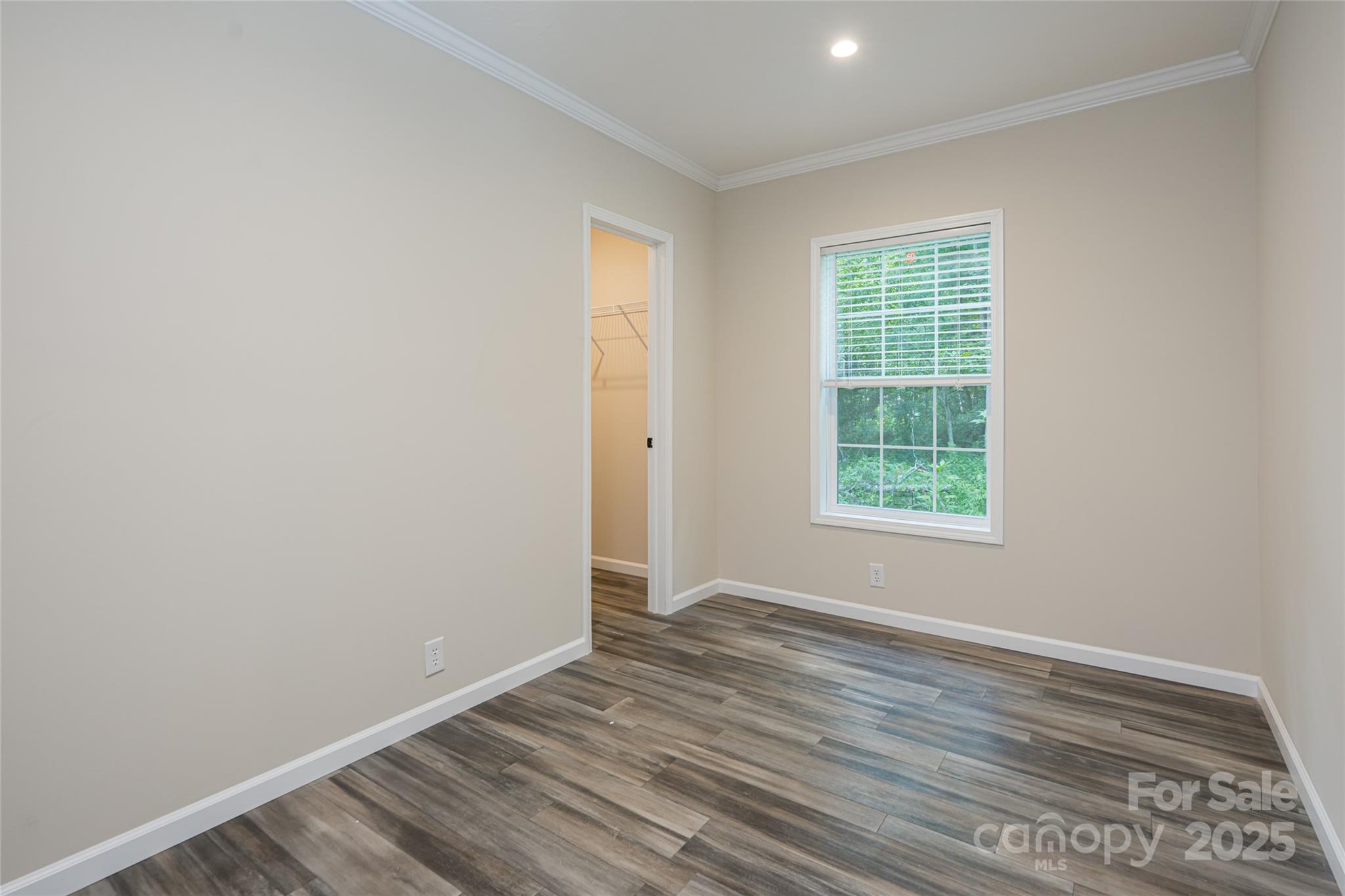321 Flat Creek Road Black Mountain, NC 28711 - Photo 32 of 44 an empty room with wooden floor and windows