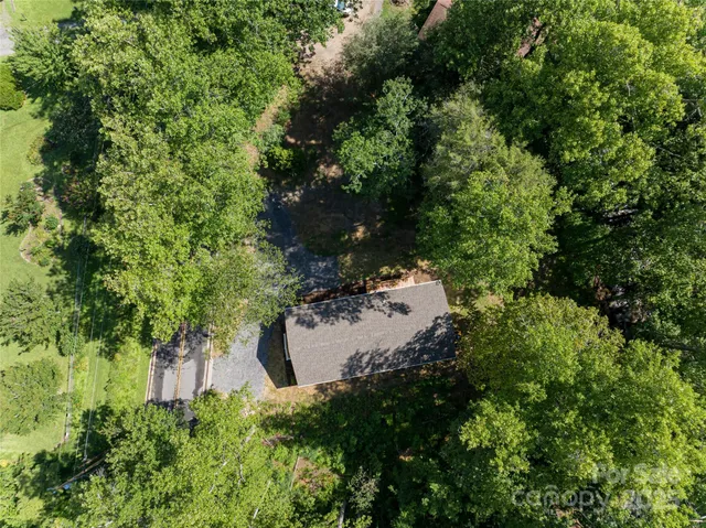 an aerial view of a house with yard