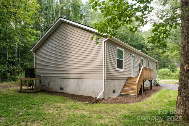 a view of backyard with wooden fence and a bench