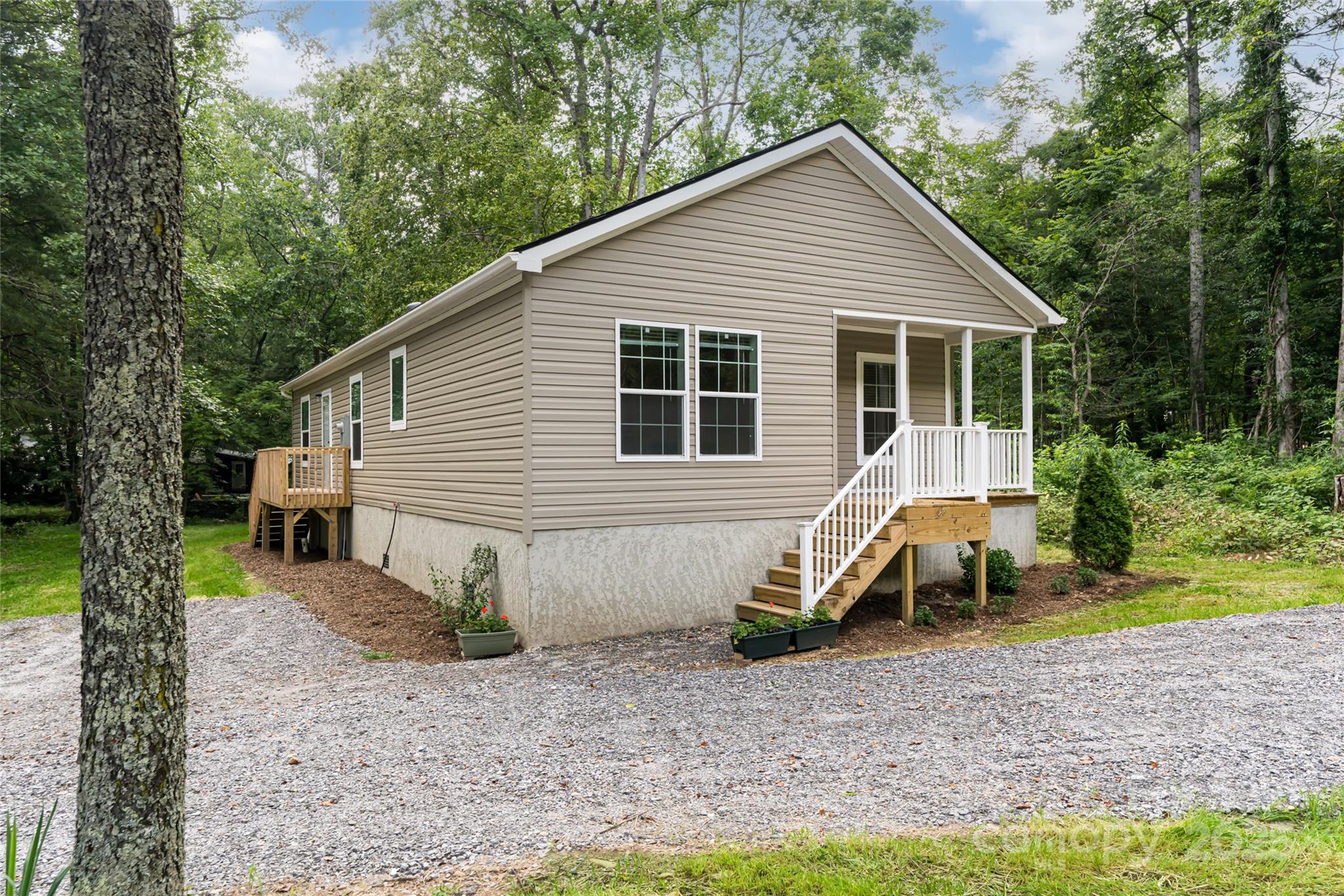 321 Flat Creek Road Black Mountain, NC 28711 - Photo 43 of 44 a view of a small house with a yard and large trees