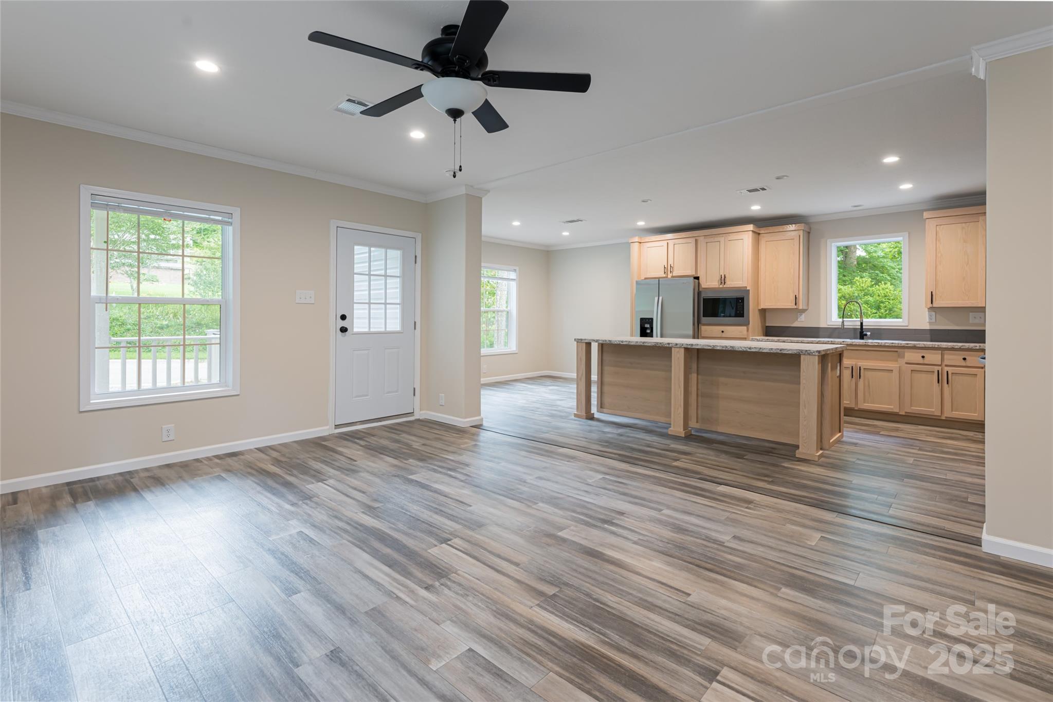 321 Flat Creek Road Black Mountain, NC 28711 - Photo 6 of 44 an open kitchen with kitchen island wooden floors and stainless steel appliances