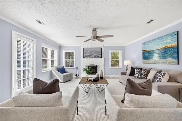 a living room with furniture large window and fireplace