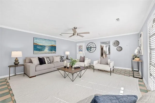 a living room with furniture and wooden floor