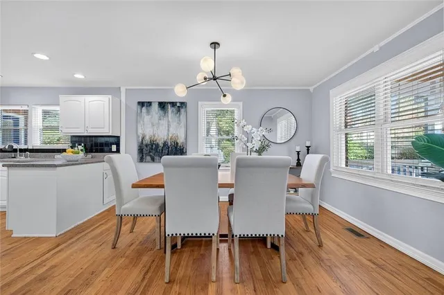 a view of a dining room with furniture window and wooden floor