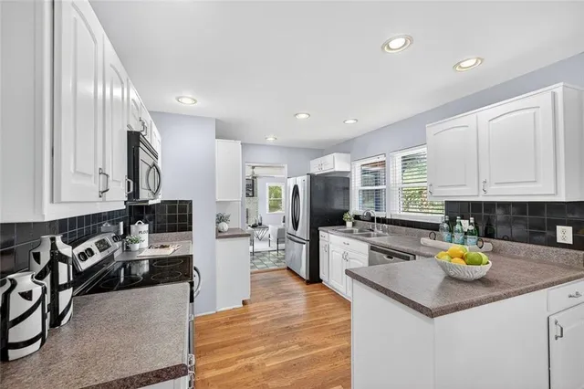 a kitchen with a sink appliances and cabinets