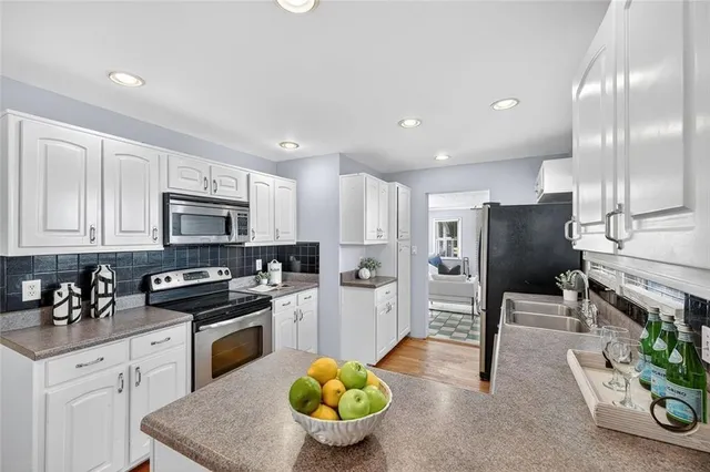 a kitchen with a sink stainless steel appliances and cabinets