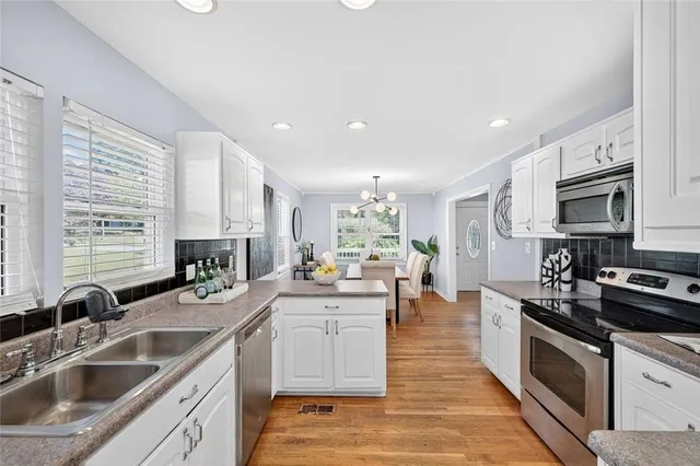 a kitchen with a sink stove cabinets and counter space