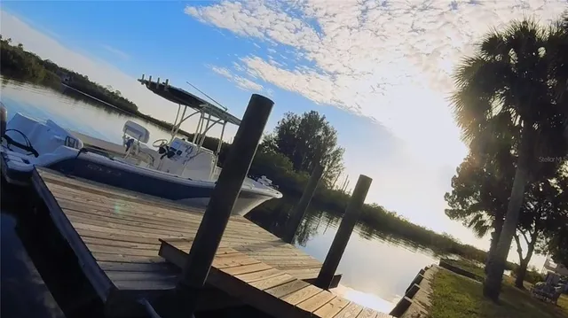 a view of balcony with wooden floor and outdoor seating