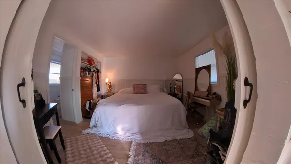 a room with a window and wooden floor
