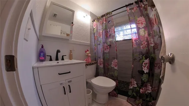 a living room with furniture a window and a flat screen tv