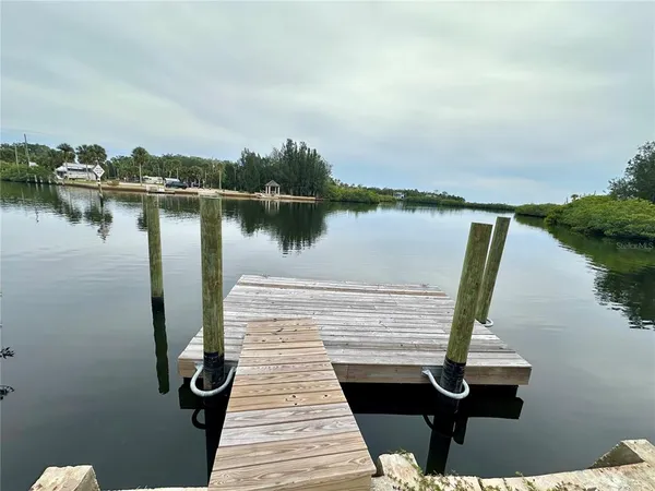 a view of a lake with houses in the back