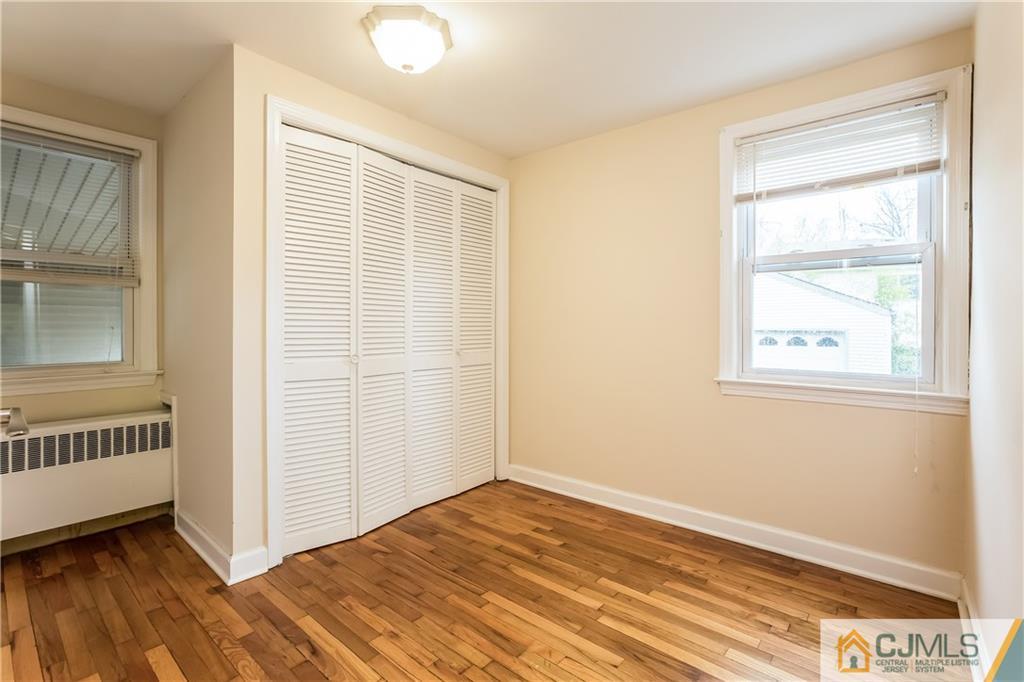 41 West Cliff Road Colonia, NJ 07067 - Photo 11 of 23 wooden floor in an empty room with a window
