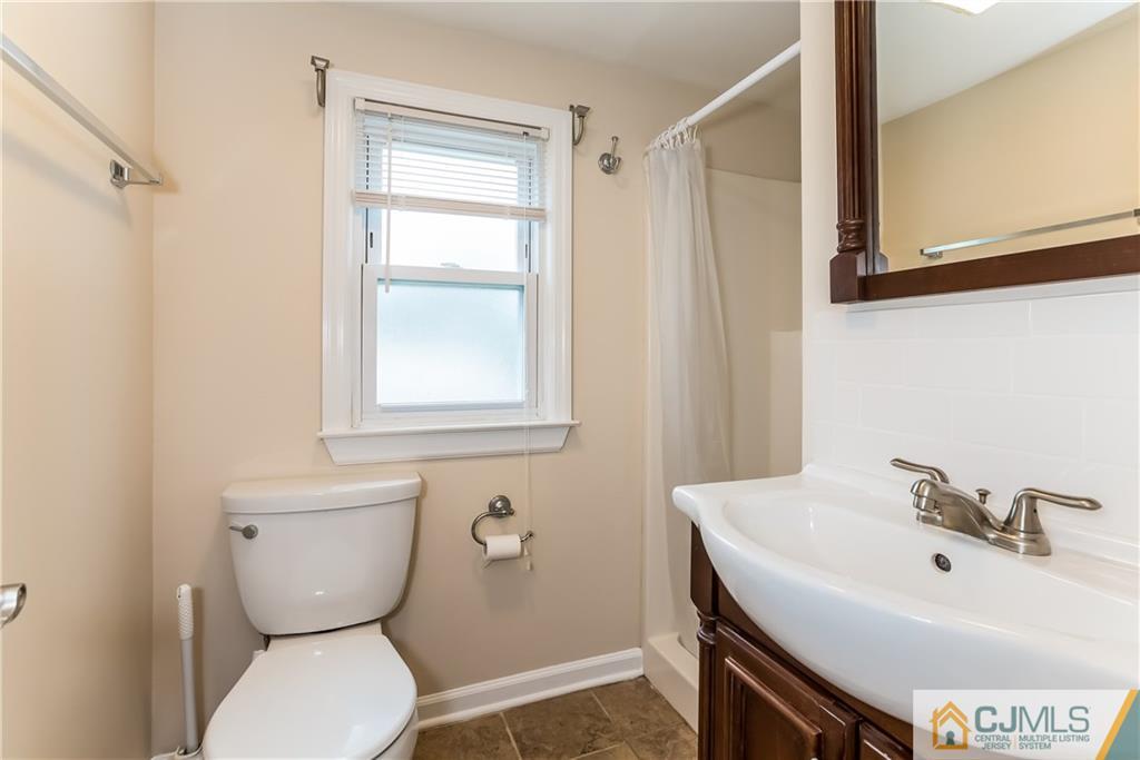 41 West Cliff Road Colonia, NJ 07067 - Photo 12 of 23 a bathroom with a sink a toilet and a mirror
