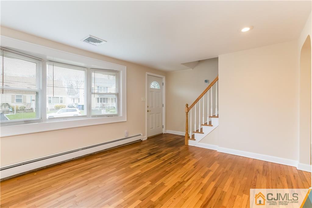 41 West Cliff Road Colonia, NJ 07067 - Photo 14 of 23 a view of an empty room with wooden floor and a window