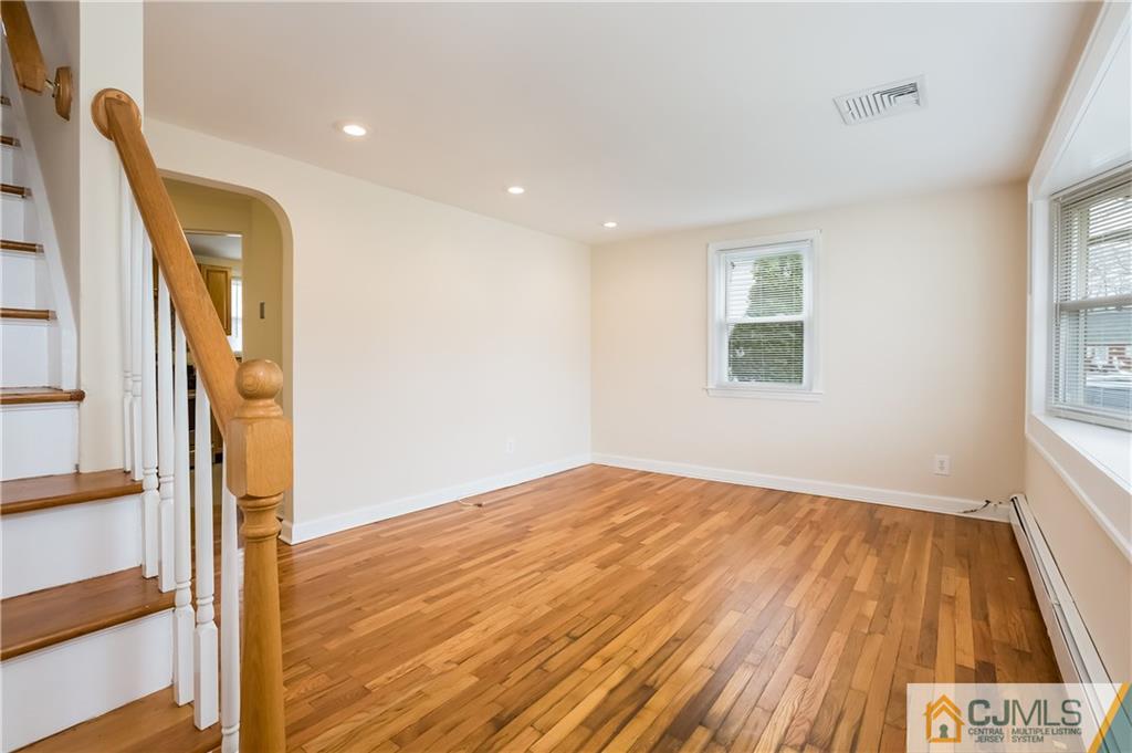 41 West Cliff Road Colonia, NJ 07067 - Photo 15 of 23 a view of an empty room with wooden floor and a window